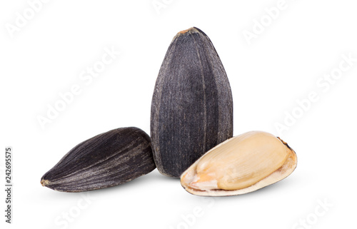 A group of sunflower seeds in the foreground closeup isolated on white background