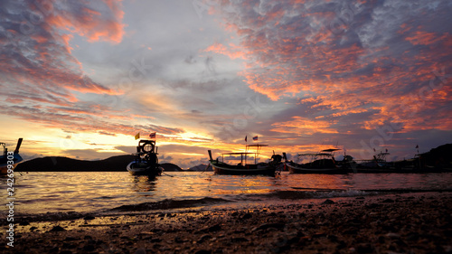 Silhouette of Long tail boats at sunset beach. Panwa Cape  Phuket Province  Thailand.