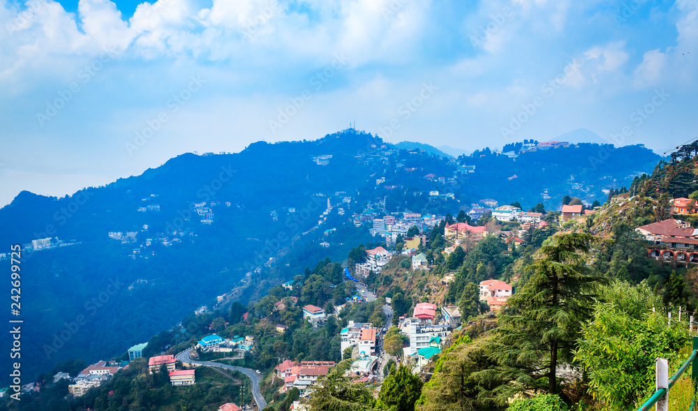 An Aerial landscape view of Mussoorie or Mussouri hill top peak city located in Uttarakhand India with colorful buildings