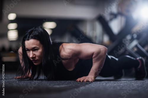 athletic woman doing push-ups in the gym. Woman doing yoga