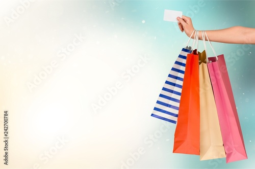 Close up woman hand with many shopping bags and credit card