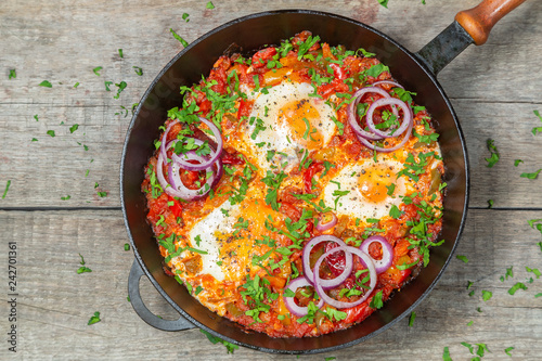 Traditional middle Eastern dish Shakshuka in a pan. The view from the top.