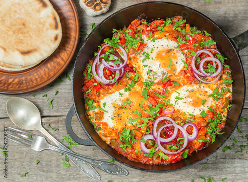 Traditional middle Eastern dish Shakshuka in a pan. The view from the top.
