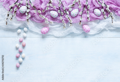 Easter decoration –painted eggs and pussy willow. Top view, close up, flat lay on white wooden background