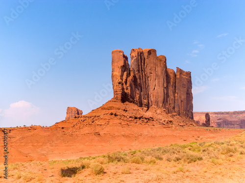 Tourist in front of beautiful sandstone rock Camel Butte
