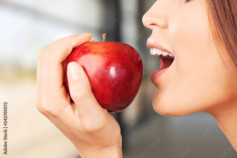 Young woman holding fresh apple on white background Young woman holding fresh apple on white background