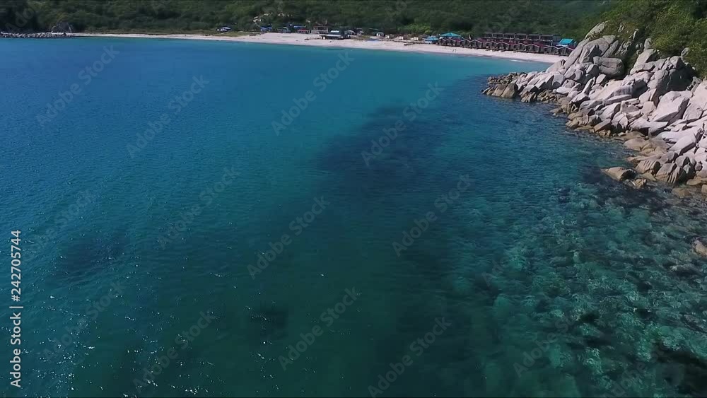 Aerial shot of mountain cliff and blue sea water. Rocky cliff and blue water in sea bay aerial landscape from above. Aerial shot of mountain cliff and blue sea water. Rocky cliff and blue water in sea bay aerial landscape from above.