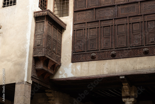 The Bayt Al-Suhaymi house is built around a sahn in the centre of which there is a small garden with plants and palm trees, rom here several of the fine mashrabiya windows in the house can be seen. photo