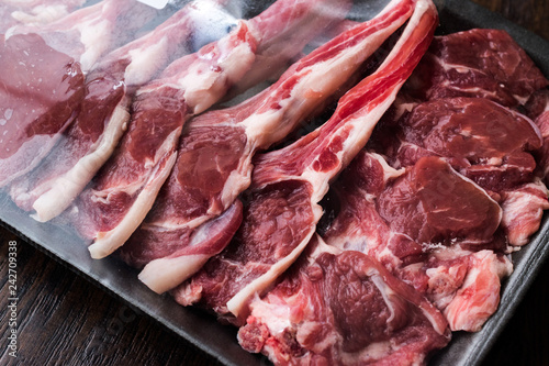 Package of Raw Lamb Chops Meat in Plastic Box / Container.