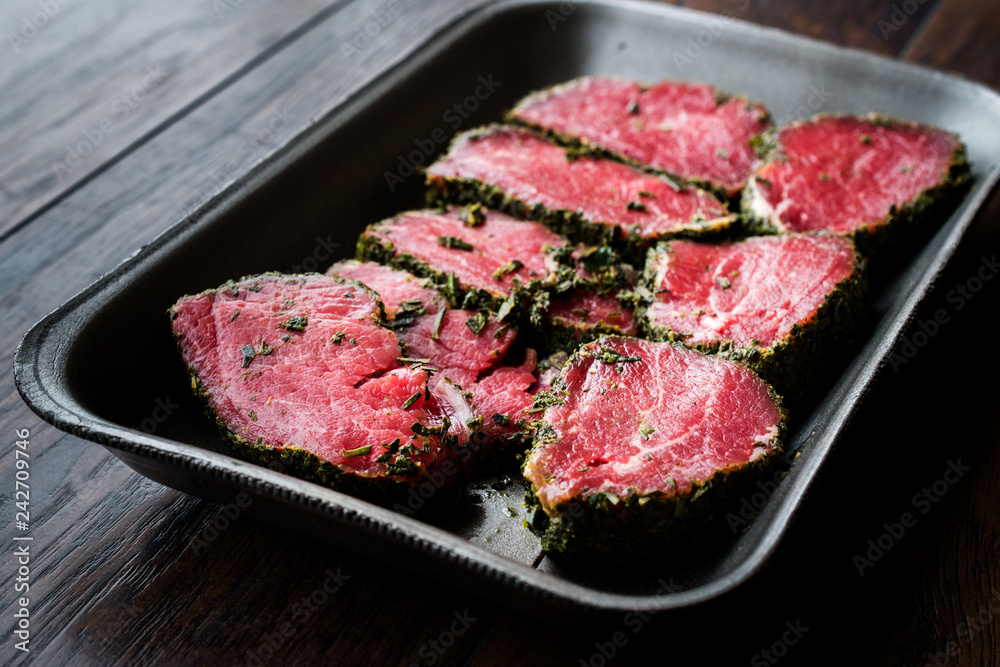 Package of Raw Tenderloin Meat with Herbs and Spices in Plastic Box / Container. Package of Raw Tenderloin Meat with Herbs and Spices in Plastic Box / Container.