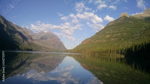 Upper Kintla Lake Glacier National Park in Montana. Beautiful reflection in lake flanked by forest of trees and mountain peaks. Utopian paradise away from cities and crowds very peaceful