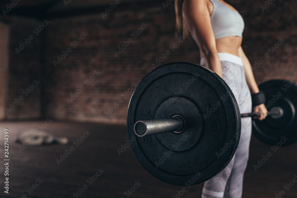 Fitness woman exercising with heavy weights Fitness woman exercising with heavy weights