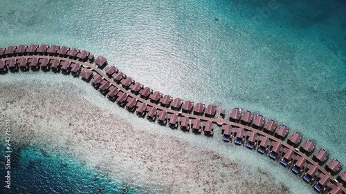 Beautiful winding row of bungalows in water at Maldives