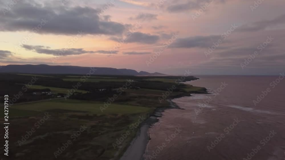 Aerial view of a beach on the Atlantic Ocean Coast during a dramatic sunrise. Taken in Codroy Valley, Newfoundland, Canada. Aerial view of a beach on the Atlantic Ocean Coast during a dramatic sunrise. Taken in Codroy Valley, Newfoundland, Canada.