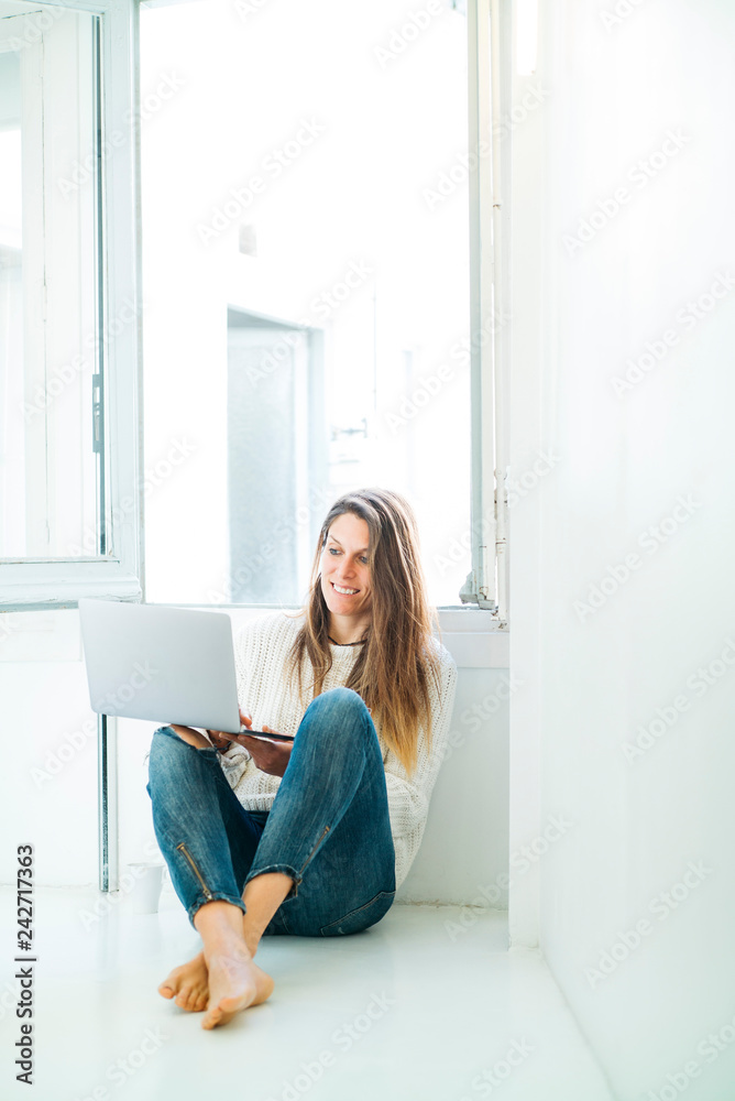 Attractive woman with laptop at home
