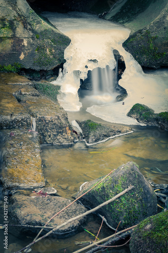 Fototapeta Naklejka Na Ścianę i Meble -  moss on stones in blured water waterfall