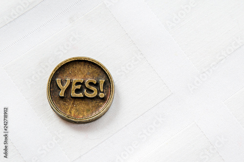 Bronze metal coin Yes or No. Coin for make choice. On white background. Decision making photo