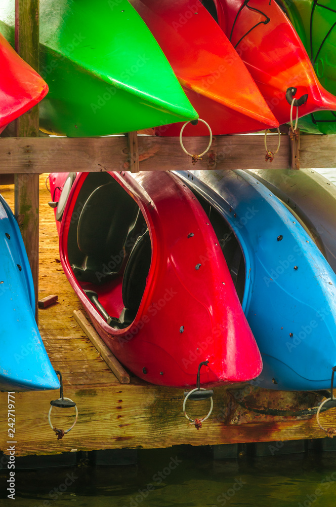 Colorful kayaks tied up on Hilton Head Island dock on water. Colorful kayaks tied up on Hilton Head Island dock on water.
