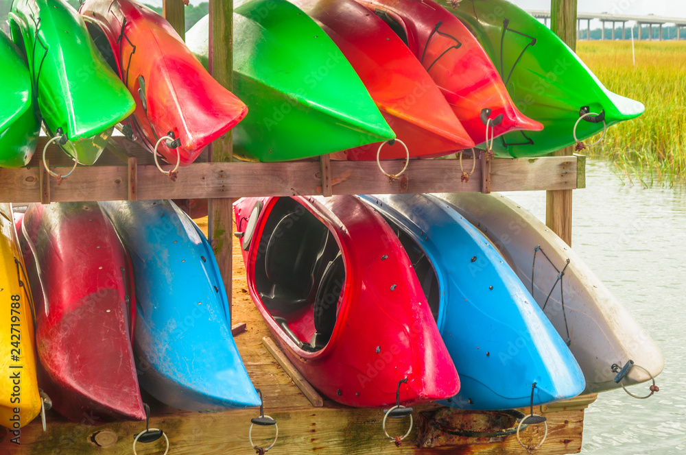 Colorful kayaks tied up on Hilton Head Island dock on water. Stock Photo Adobe Stock