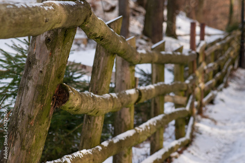 wooden old fence under the snow. selective focus. perspective.