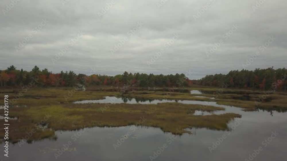 Aerial view of a beautiful lake during a cloudy autumn day. Taken in Lily Lake, near Annapolis, Nova Scotia, Canada. Aerial view of a beautiful lake during a cloudy autumn day. Taken in Lily Lake, near Annapolis, Nova Scotia, Canada.