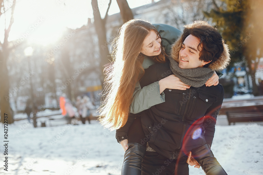 Loving couple walking in a winter park Loving couple walking in a winter park