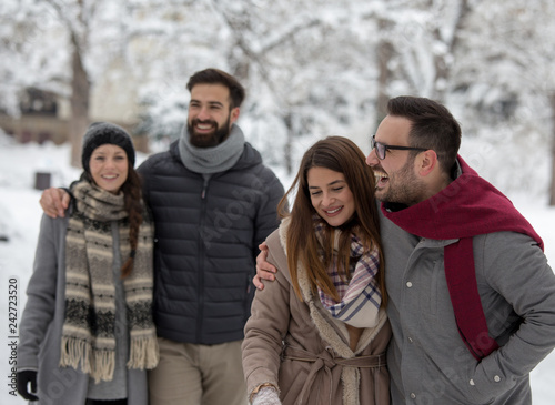 Couples walking in park on snow