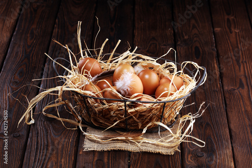 Egg. Fresh farm eggs in basket. Easter egg with feather concept