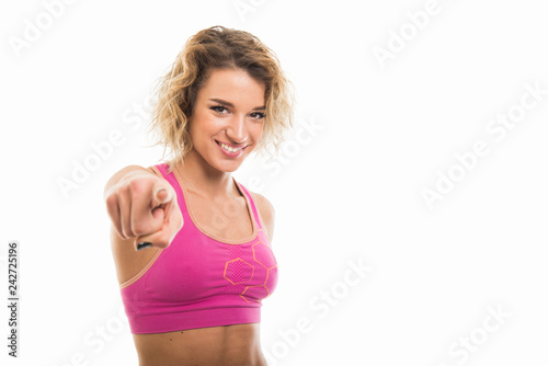 Portrait of beautiful young fit girl pointing camera