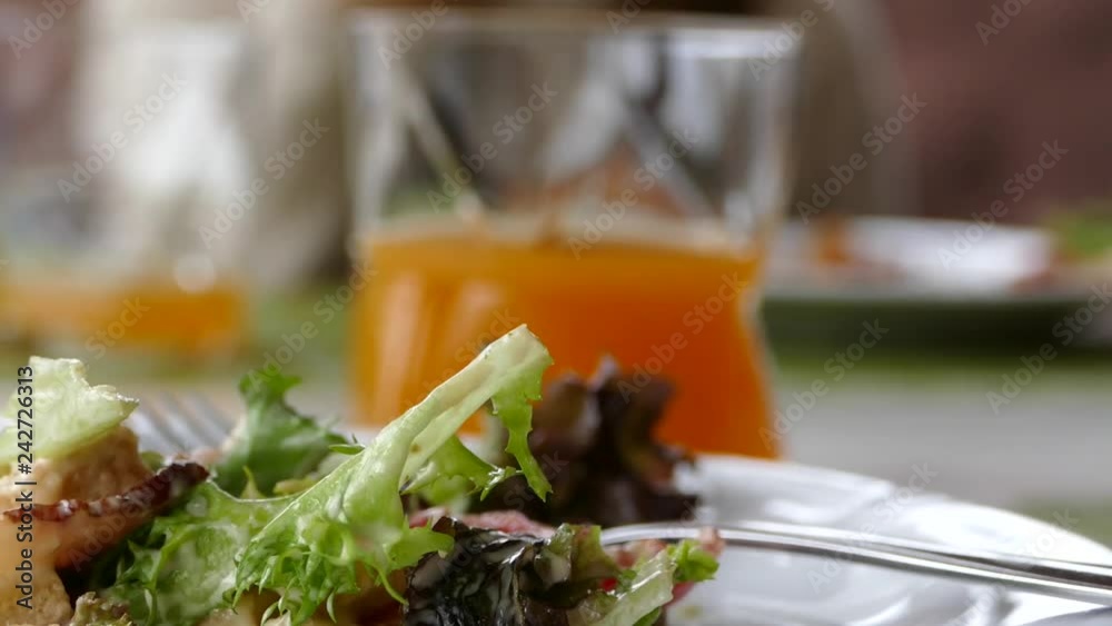 Children eat pizza and drink juice in a pizzeria. Dine with the family in a cozy cafe. The girl drinks juice and smiles. Children eat pizza and drink juice in a pizzeria. Dine with the family in a cozy cafe. The girl drinks juice and smiles.