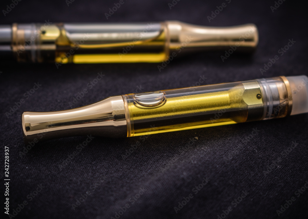 THC/CBD Cannabis Oil & Terpenes Filled Cartridges Isolated Up Close On Black THC/CBD Cannabis Oil & Terpenes Filled Cartridges Isolated Up Close On Black