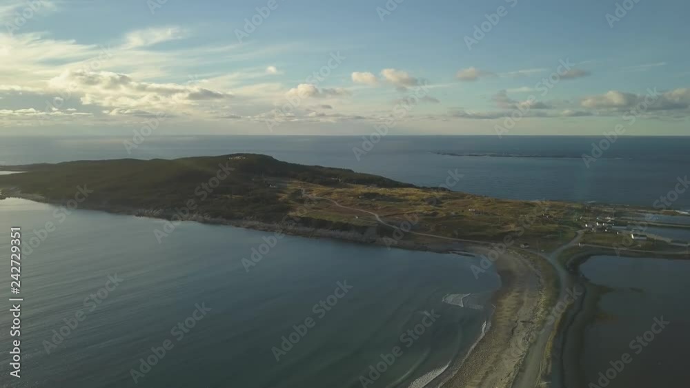 Aerial view of a small town on the Atlantic Ocean Coast during a vibrant sunny sunset. Taken in Cow Head, Newfoundland, Canada. Aerial view of a small town on the Atlantic Ocean Coast during a vibrant sunny sunset. Taken in Cow Head, Newfoundland, Canada.