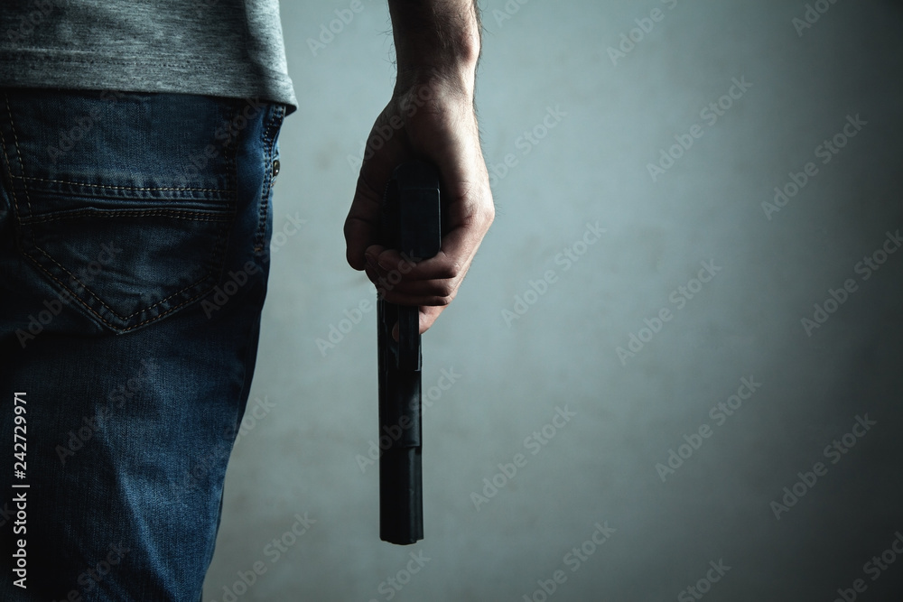 Fototapeta Man holding pistol. Criminal concept