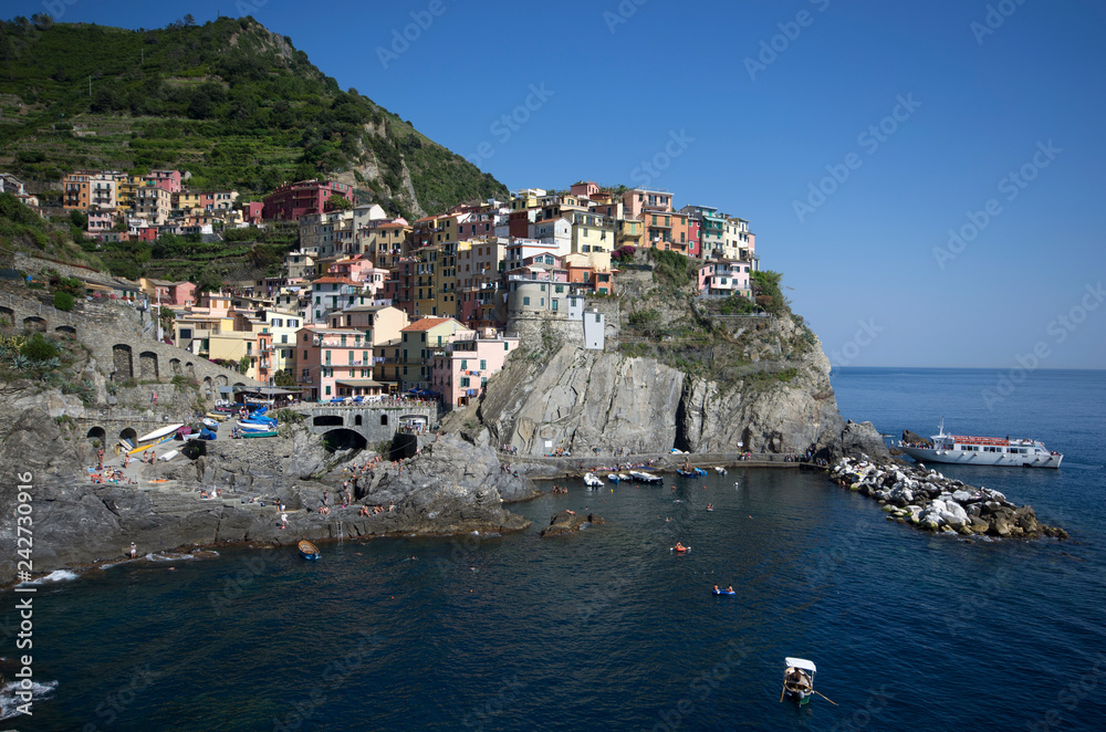 Manarola, Liguria / Italy - June 23 / 2016: View of village built on cliffs, Manarola from the seaside 