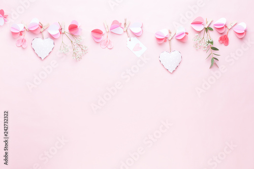 Colorful paper garland of hearts on the living coral background. Valentine day greeting cards.