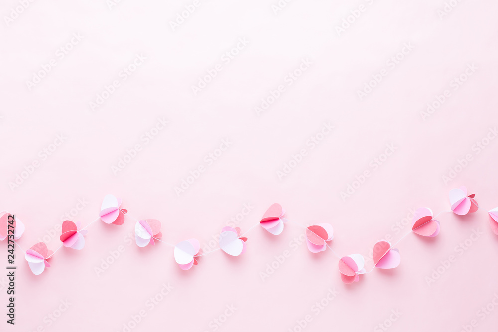 Colorful paper garland of hearts on the living coral background. Valentine day greeting cards. Colorful paper garland of hearts on the living coral background. Valentine day greeting cards.