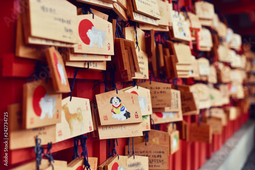 Wishes tied to nails on wooden board at temple photo