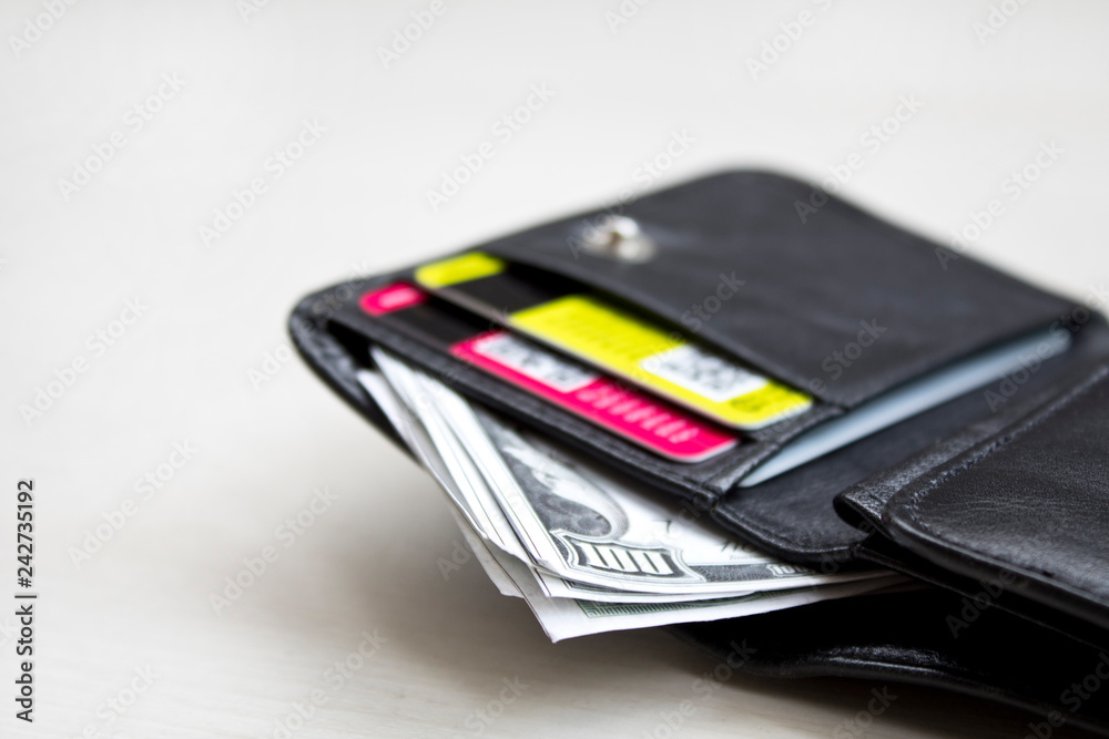 men's black wallet money in cash wooden white vintage background. men's black wallet money in cash wooden white vintage background.
