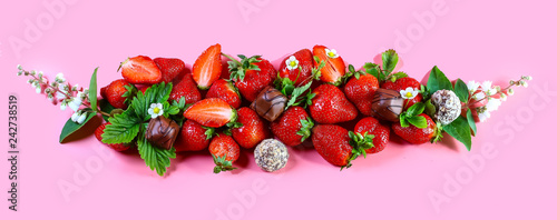 Fresh  red strawberries on pink background  top view. copy space
