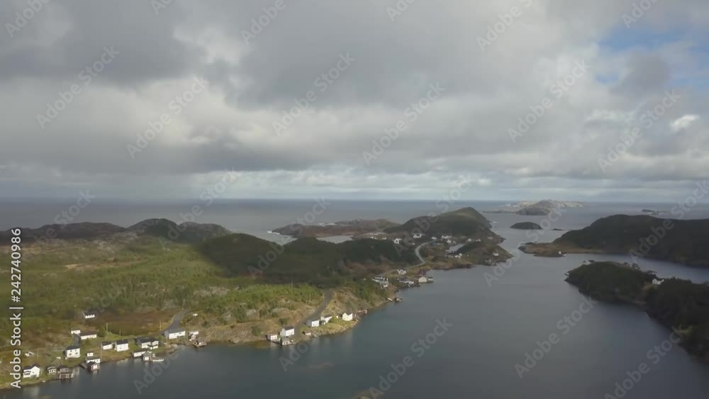 Aerial view of a small town on a rocky Atlantic Ocean Coast during a cloudy day. Taken in Herring Neck, Newfoundland, Canada. Aerial view of a small town on a rocky Atlantic Ocean Coast during a cloudy day. Taken in Herring Neck, Newfoundland, Canada.