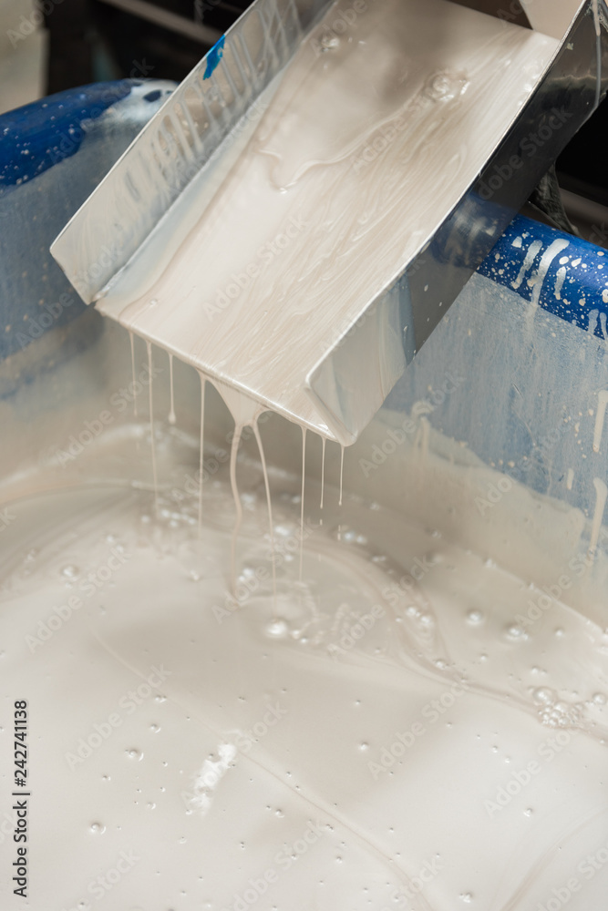 An industrial paint and colour mixing machine mixing paint in an industrial machine. paint