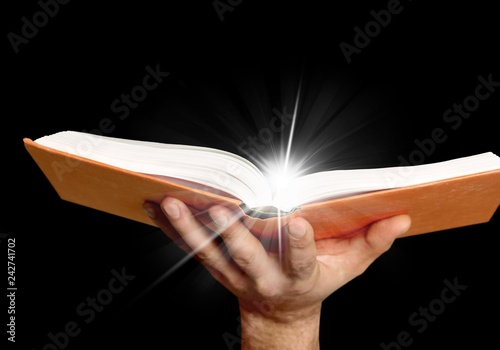 Young man hands holding open book