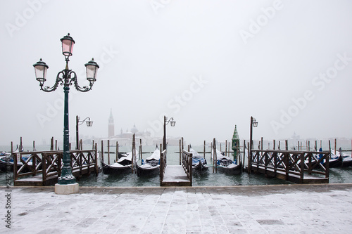 Venice in snow with gondolas on St. Mark square, snowing in Venice, Italy, march 2018
