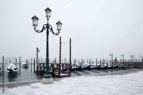 Venice in snow with gondolas on St. Mark square, snowing in Venice, Italy, march 2018