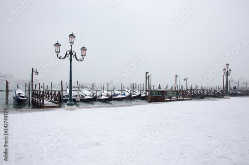Snowing in Venice with gondolas on St. Mark square, Venice, Italy, march 2018