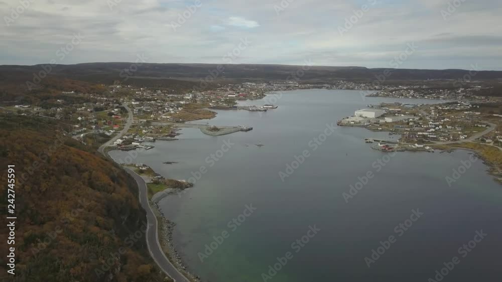 Aerial view of a small town on a rocky Atlantic Ocean Coast during a cloudy day. Taken in St. Anthony, Newfoundland, Canada. Aerial view of a small town on a rocky Atlantic Ocean Coast during a cloudy day. Taken in St. Anthony, Newfoundland, Canada.