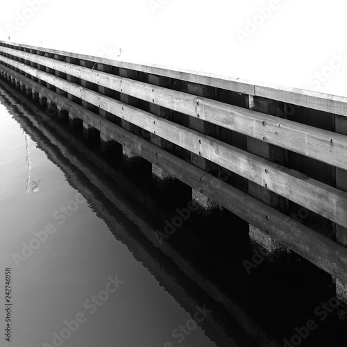 Laesoe / Denmark: View along the pier construction in the marina in Vesteroe Havn on a sunny day in April photo