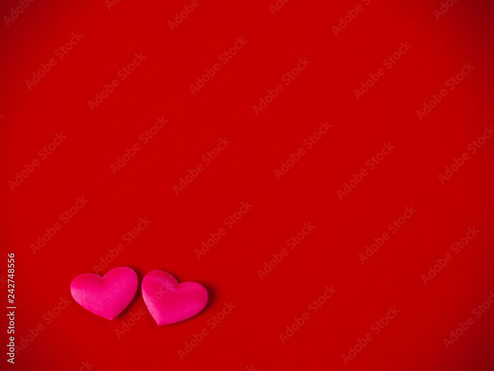Concept of love Two small hearts on a red background