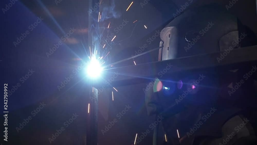 Welder Worker Performs Jump Welding. Worker Welder Performs ArcWelding