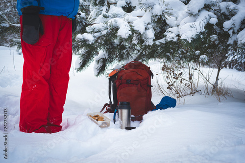 Traveler relaxing and drinking coffee from thermos